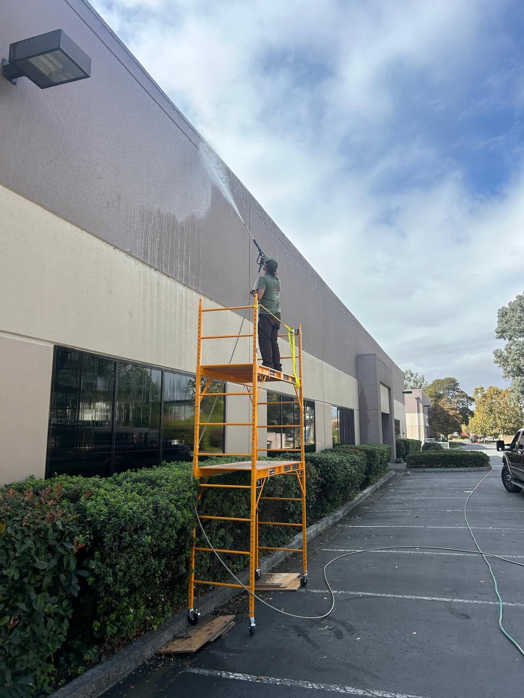 picture of a commercial building being pressure washed